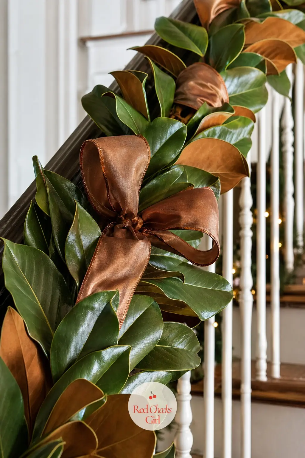 A Magnolia Leaf Garland Banded With Copper Wire-Edged Ribbon — Glossy magnolia leaves, their undersides a soft bronze, run the length of the rail as a single