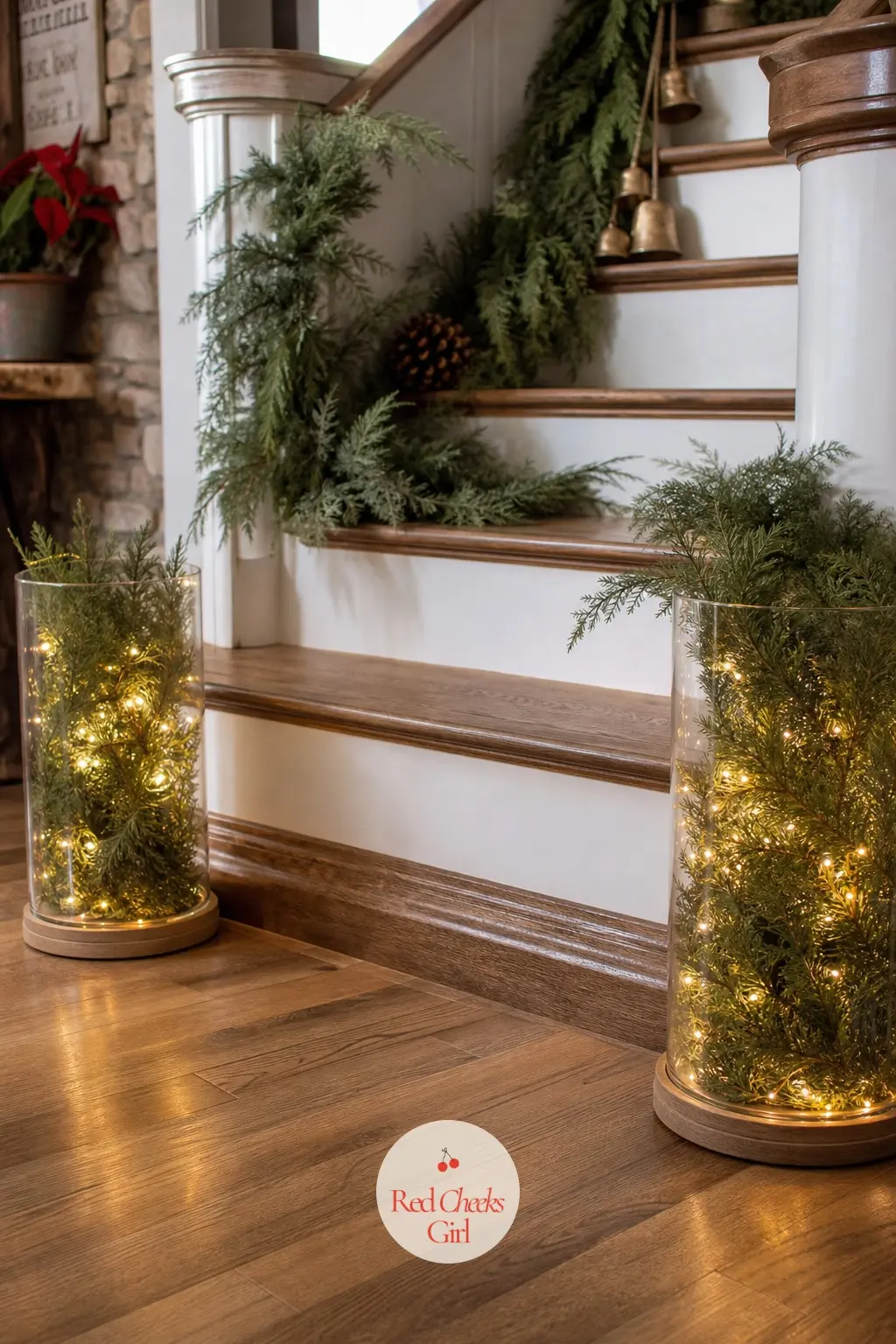 A Pair of Glass Hurricane Lanterns Flanking the Bottom Step Filled With Cedar and Amber Fairy Lights — Two matching glass hurricane lanterns sit at the foot of