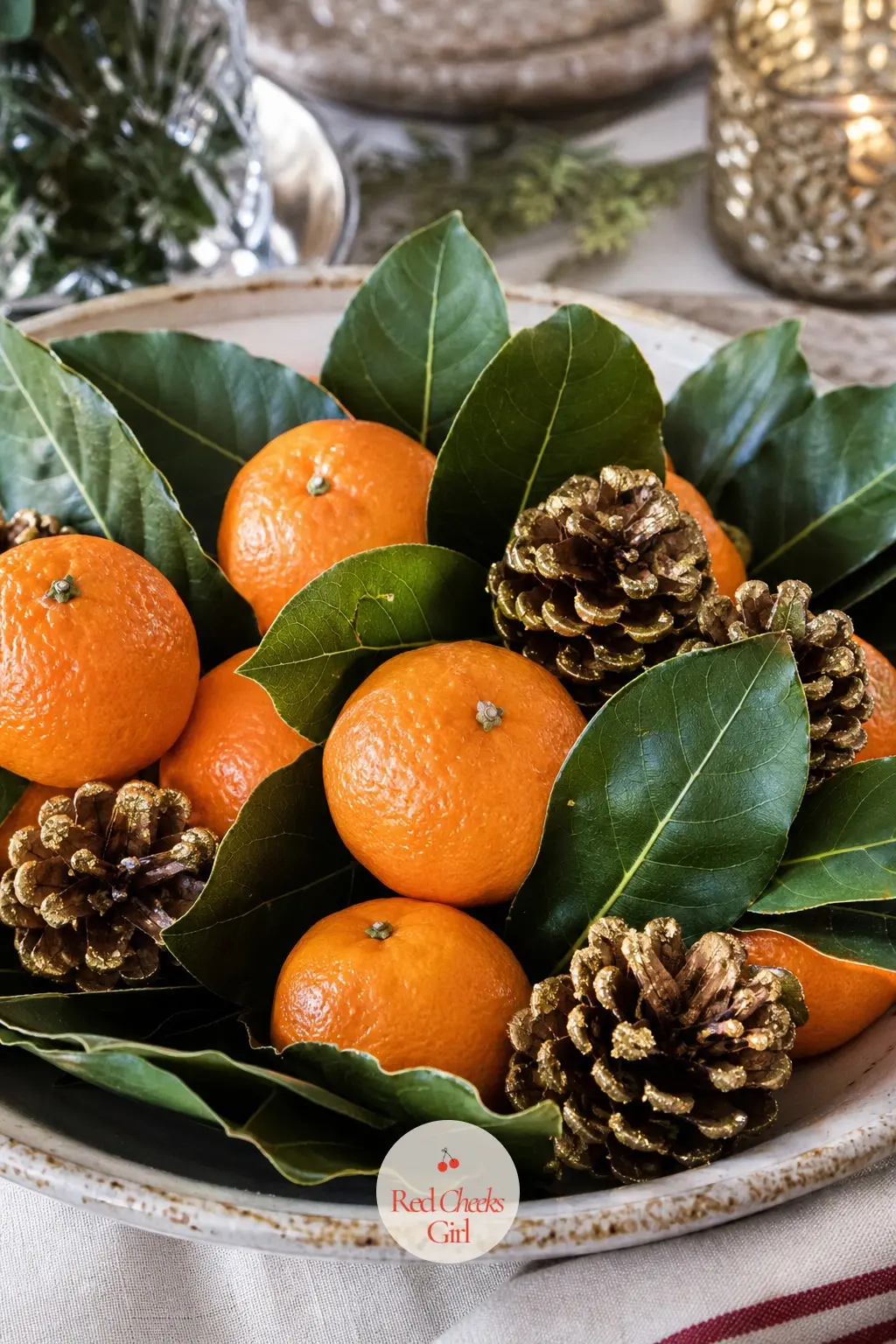A Low Bowl of Clementines, Bay Leaves and Gold-Dipped Pinecones — This centerpiece costs almost nothing and smells better than any candle on the table.