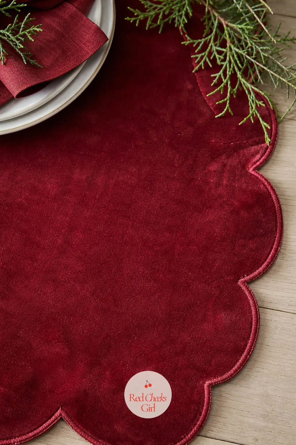 A Scalloped Cranberry Velvet Placemat at Every Seat — A scalloped edge turns a plain placemat into something with a bit of occasion to it, and cranberry velvet
