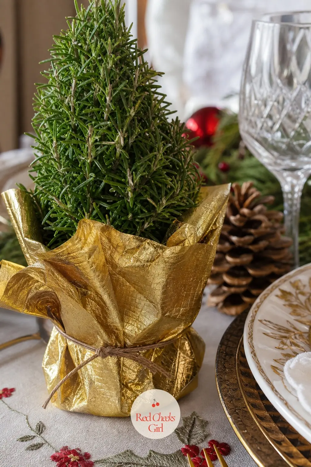 A Tiny Rosemary Topiary Wrapped in Gold Foil — A small live rosemary plant trimmed into a neat little tree shape and wrapped at the pot in gold foil paper