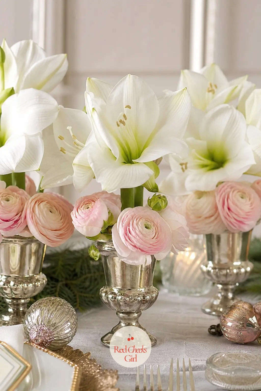 A Trio of Blush Ranunculus and White Amaryllis in Silver Urns — Three small silver urns spaced down the table do what one large arrangement cannot: guests can