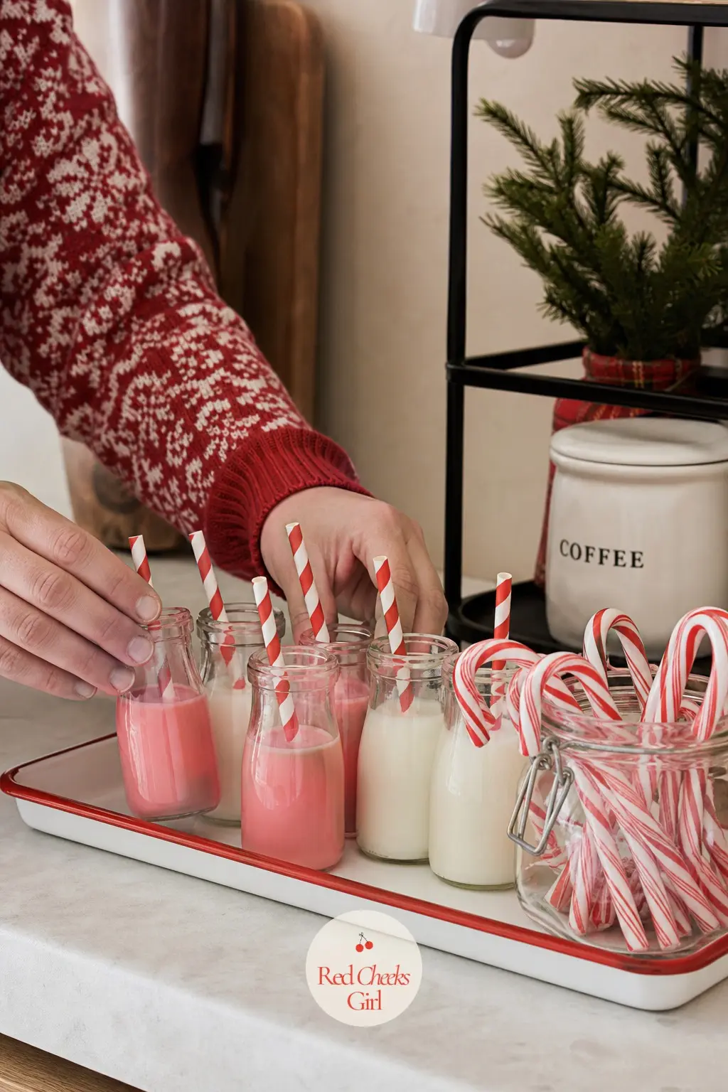 An Enamel Tray Holding Mini Milk Bottles of Peppermint Cream and a Candy Cane Jar — A row of mini glass milk bottles, each holding a splash of peppermint cream