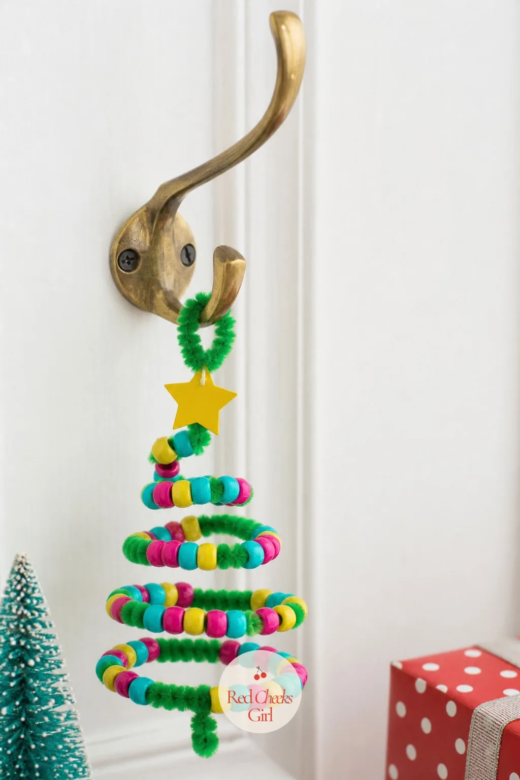 Bead and Pipe Cleaner Twist Tree — Bend a green pipe cleaner into a rough cone shape, twist the top into a small loop, then thread turquoise, magenta and
