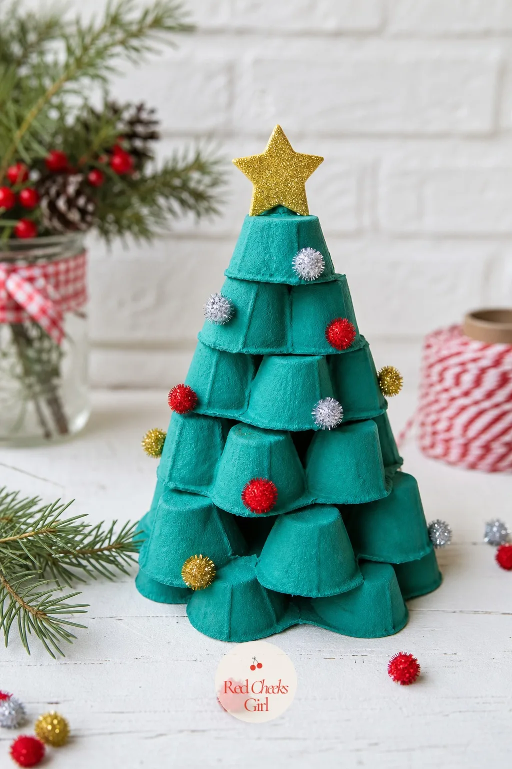 Egg Carton Tree Cups — The carton from breakfast eggs gets cut into individual cups, painted teal, and stacked upside down in a shrinking pyramid to form a