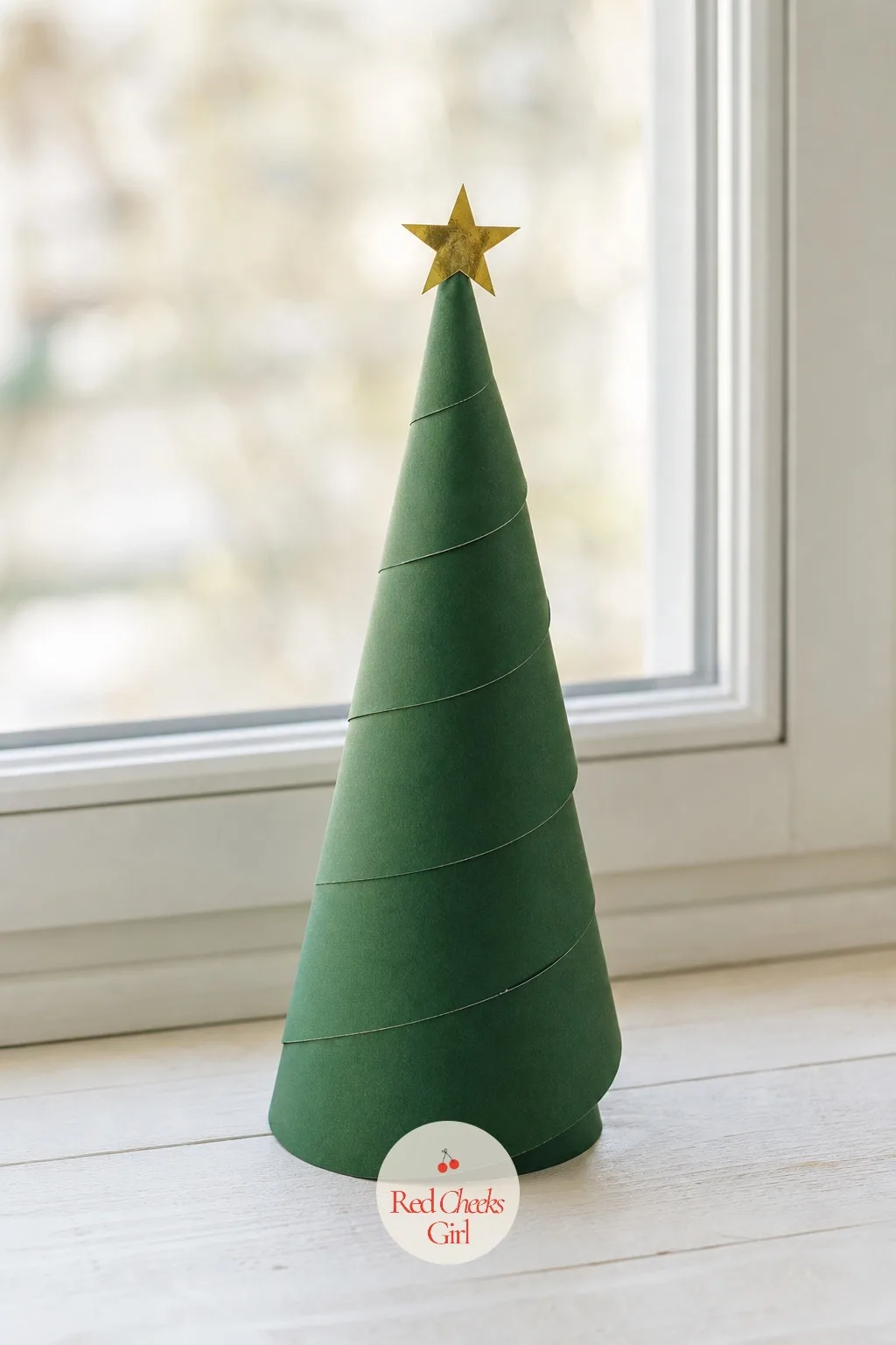 Spiral-Cut Paper Plate Tree — A flat white plate does not look like much until the scissors start. Christmas tree crafts for kids