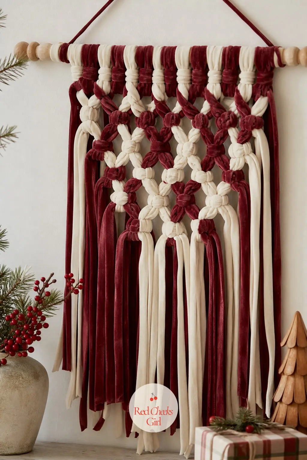 A Macrame-Style Wall Hanging Woven From Red and Cream Ribbon Tails — Swap the usual cotton cord for velvet ribbon and a macrame wall hanging stops looking like