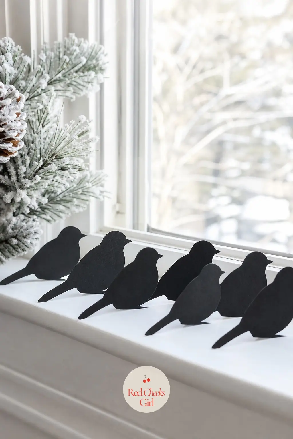 A Flock of Paper Bird Silhouettes Perched Along a Window Ledge — Cut black paper birds, propped rather than hung, look like they have actually landed on the