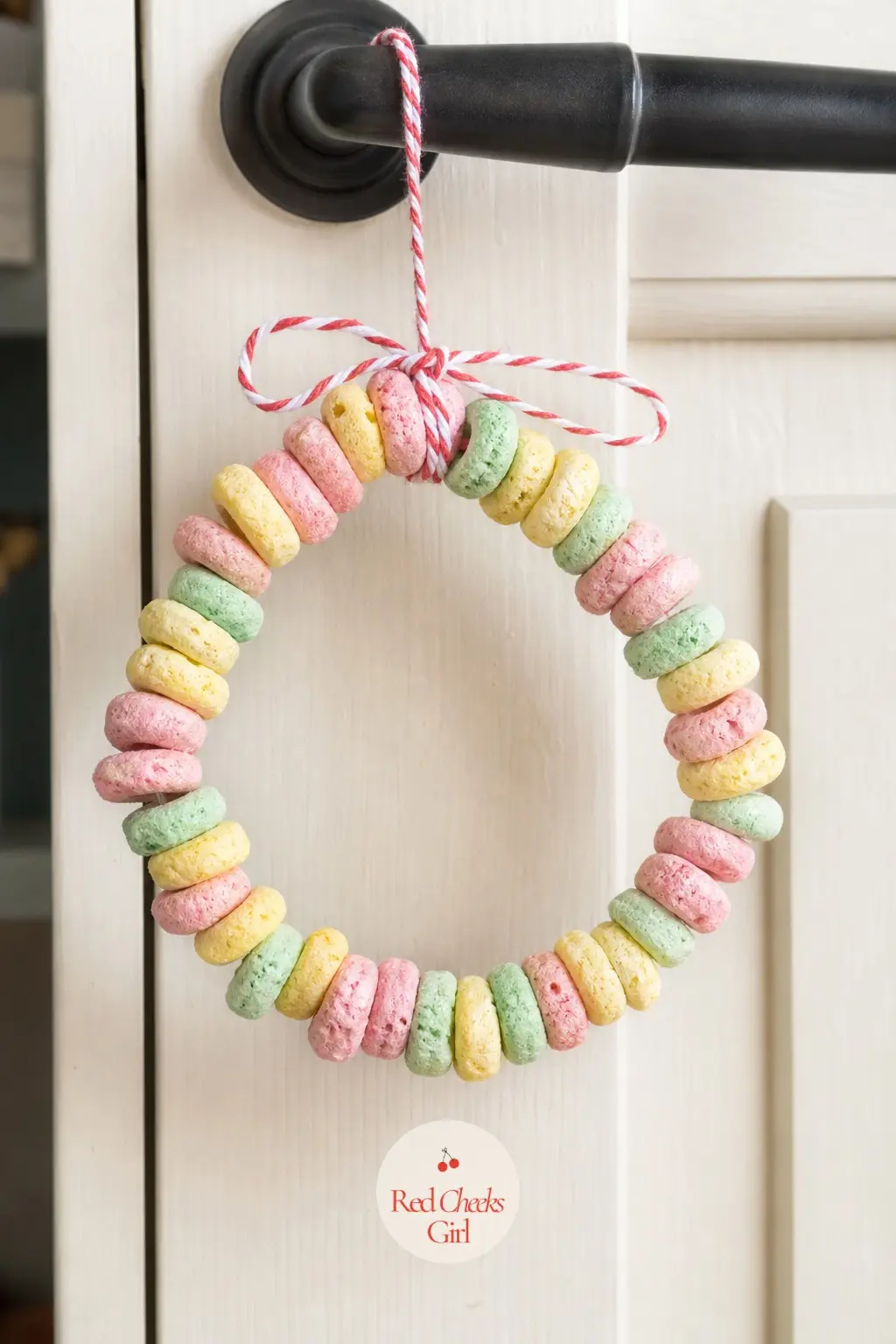 Cereal Loop Wreath — Soak toasted O cereal briefly in food coloring and let it dry on paper towels until it turns pastel pink, mint and lemon, then string it