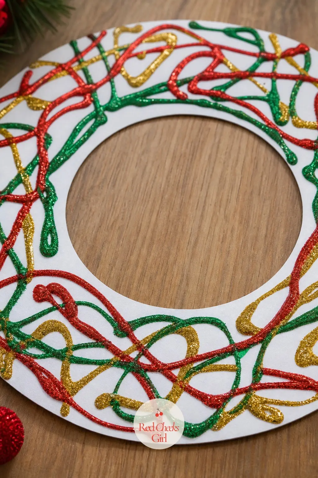 Glitter Glue Puffy Paint Wreath — Skip loose glitter altogether and let kids squeeze lines of red, green and gold glitter glue straight onto a plain paper ring