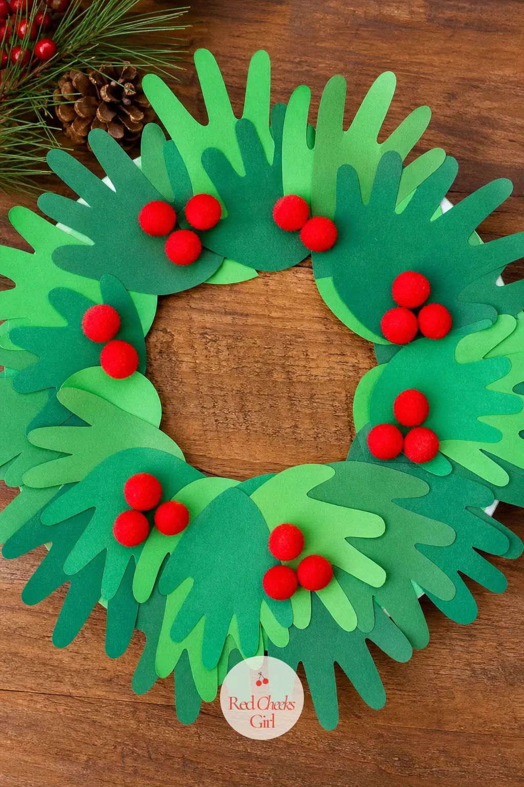Handprint Holly Wreath — Trace ten or twelve small hands on green paper, cut them out, then overlap them in pairs around a plain paper plate ring so each pair