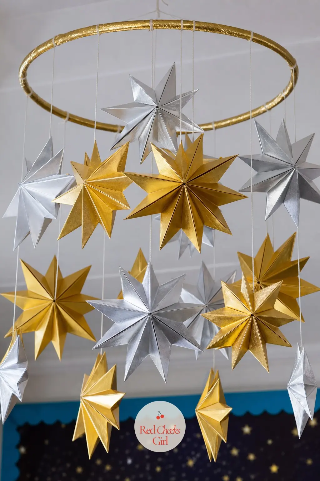 A Folded Paper Star Mobile Cluster Hung From the Ceiling — Fold a dozen origami stars in metallic gold and silver paper and suspend them from fishing line at