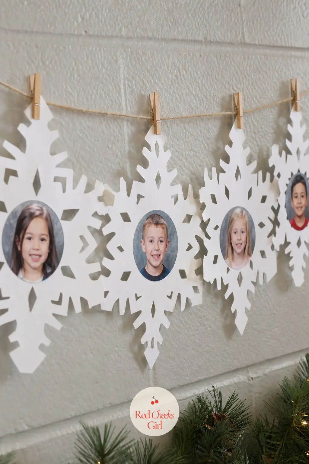 A Garland of Student Snowflake Portraits Pinned Across the Back Wall — Have each child cut a white paper snowflake and glue a small photo of their own face