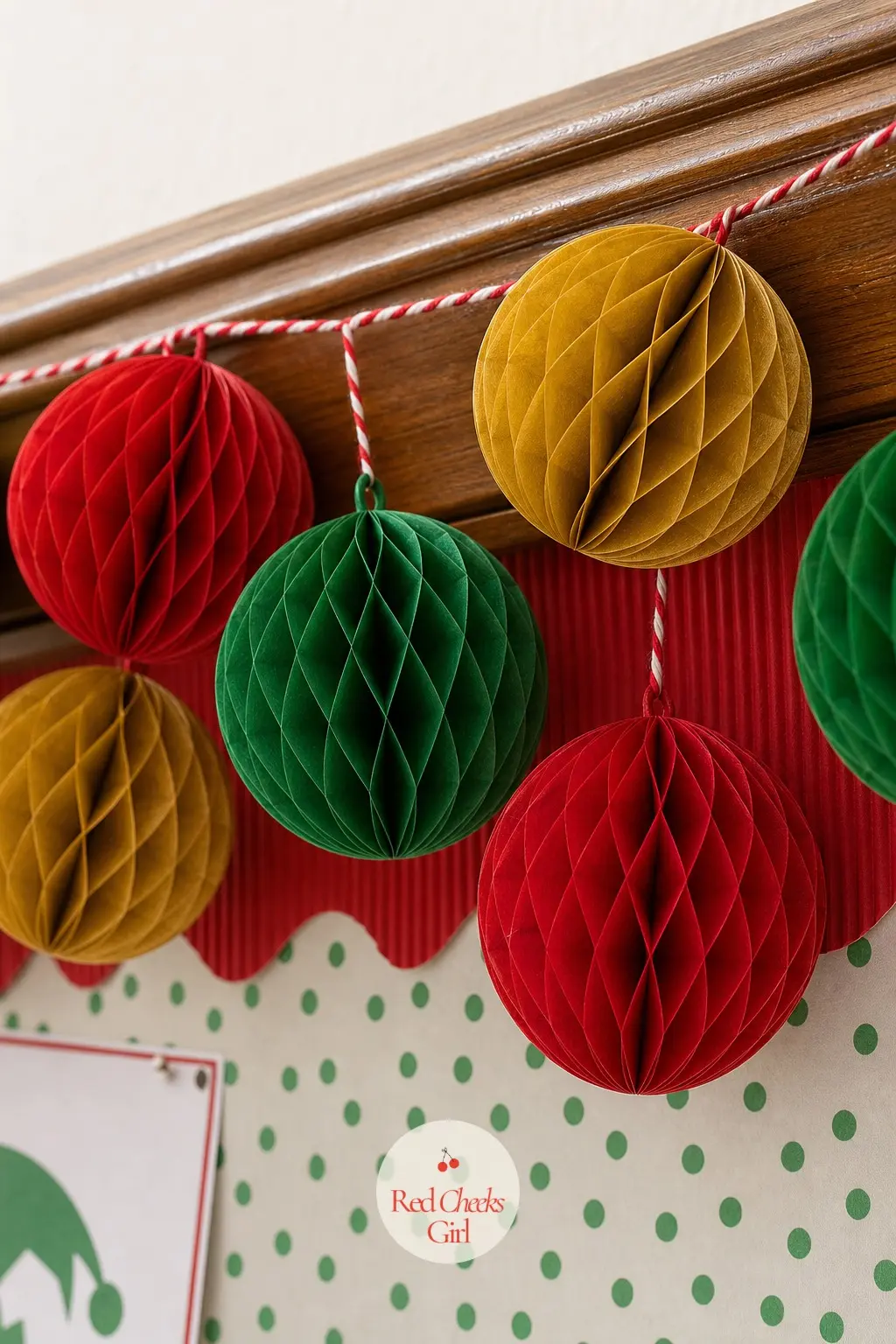 A Honeycomb Ornament Garland Looped Along the Bulletin Board Trim — String small honeycomb tissue ornaments in red, green and gold along the trim of the