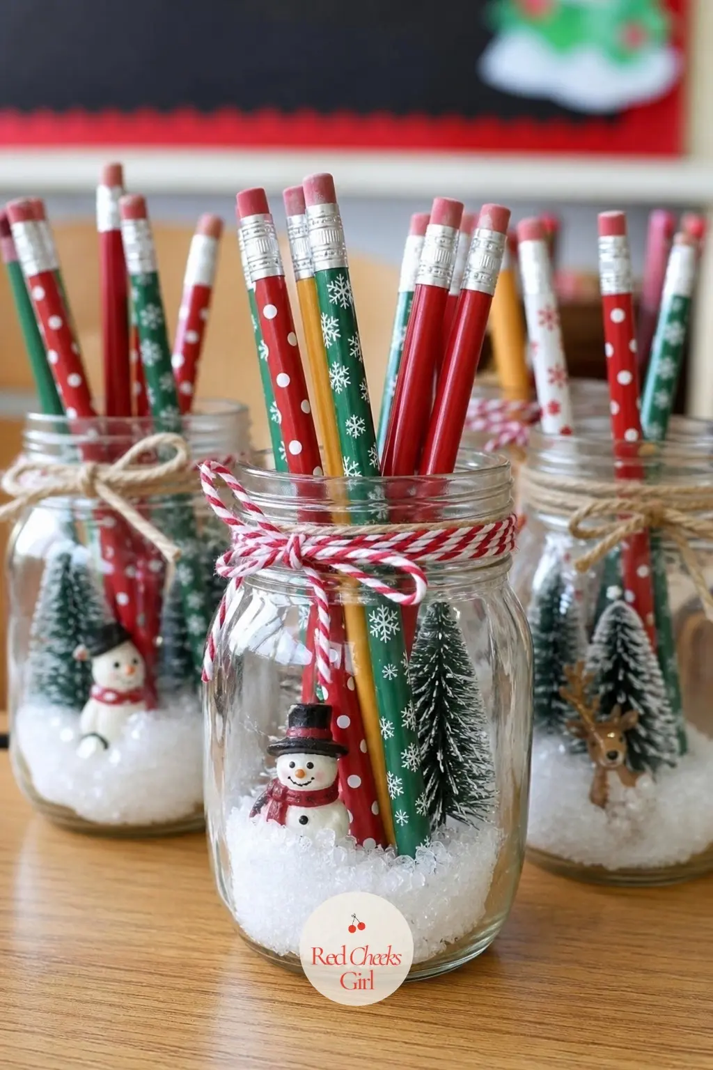 A Mini Jar Snow Scene Used as a Pencil Cup on Every Table — Fill small glass jars with a layer of fake snow and a single miniature pine or figurine, then stand