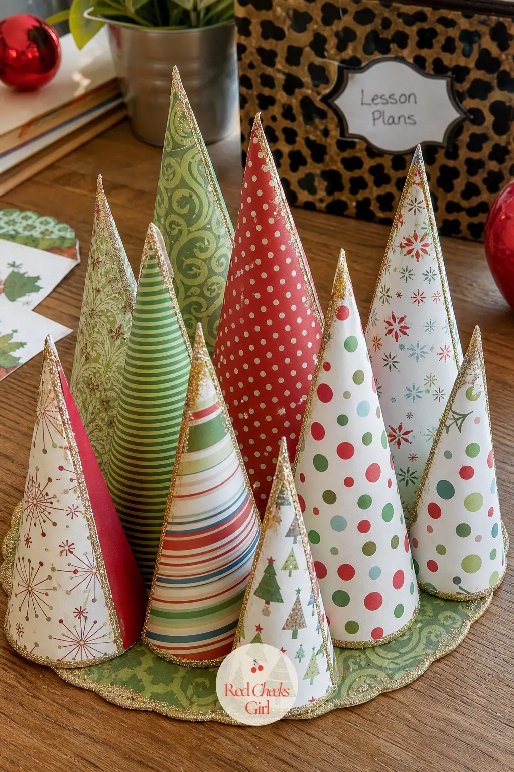 A Paper Cone Ornament Centerpiece on the Teacher's Desk — Roll a handful of patterned paper into small cone trees, dust the edges with a little glitter spray