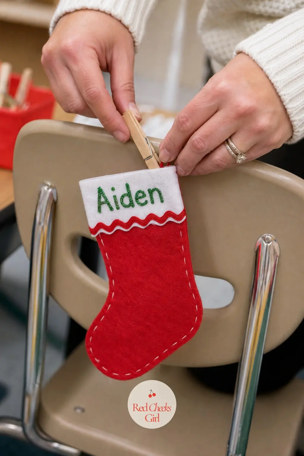 A Stocking Name Tag Clipped to Each Chair Back — Cut a small felt stocking for every child, write their name across the cuff in paint pen, and clip each one to