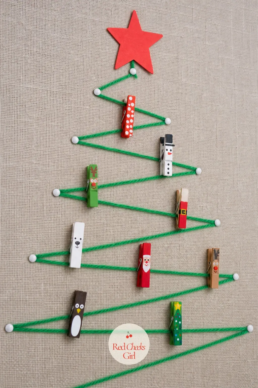 A Yarn and Peg Ornament Tree Pinned to the Bulletin Board — Wind green yarn back and forth across the bulletin board in a tree silhouette, pinned at each turn
