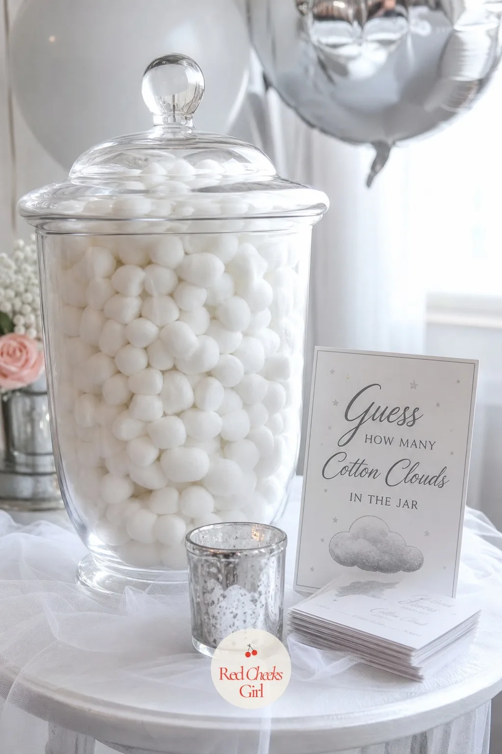 Guess How Many Cotton Clouds in the Jar — Set a large glass jar filled with small cotton ball clouds on a side table near the entrance, with a stack of small