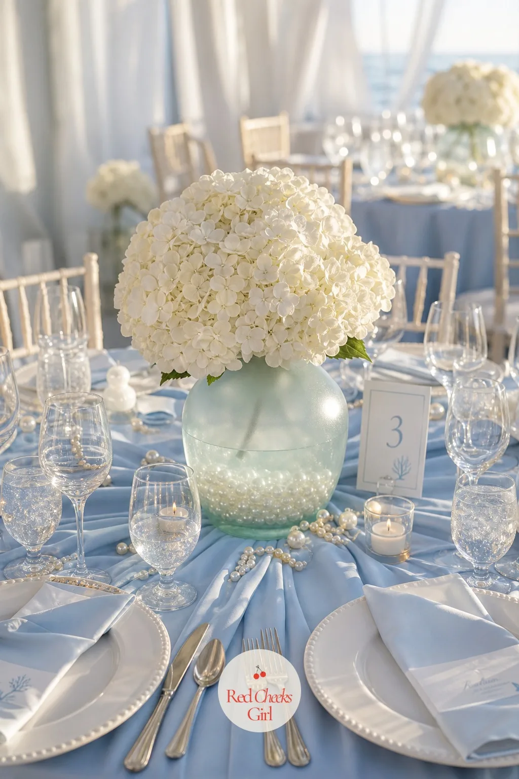 Sea Glass Vases of White Hydrangeas — A centerpiece that tries to do everything, color and height and texture all at once, usually just looks busy next to a