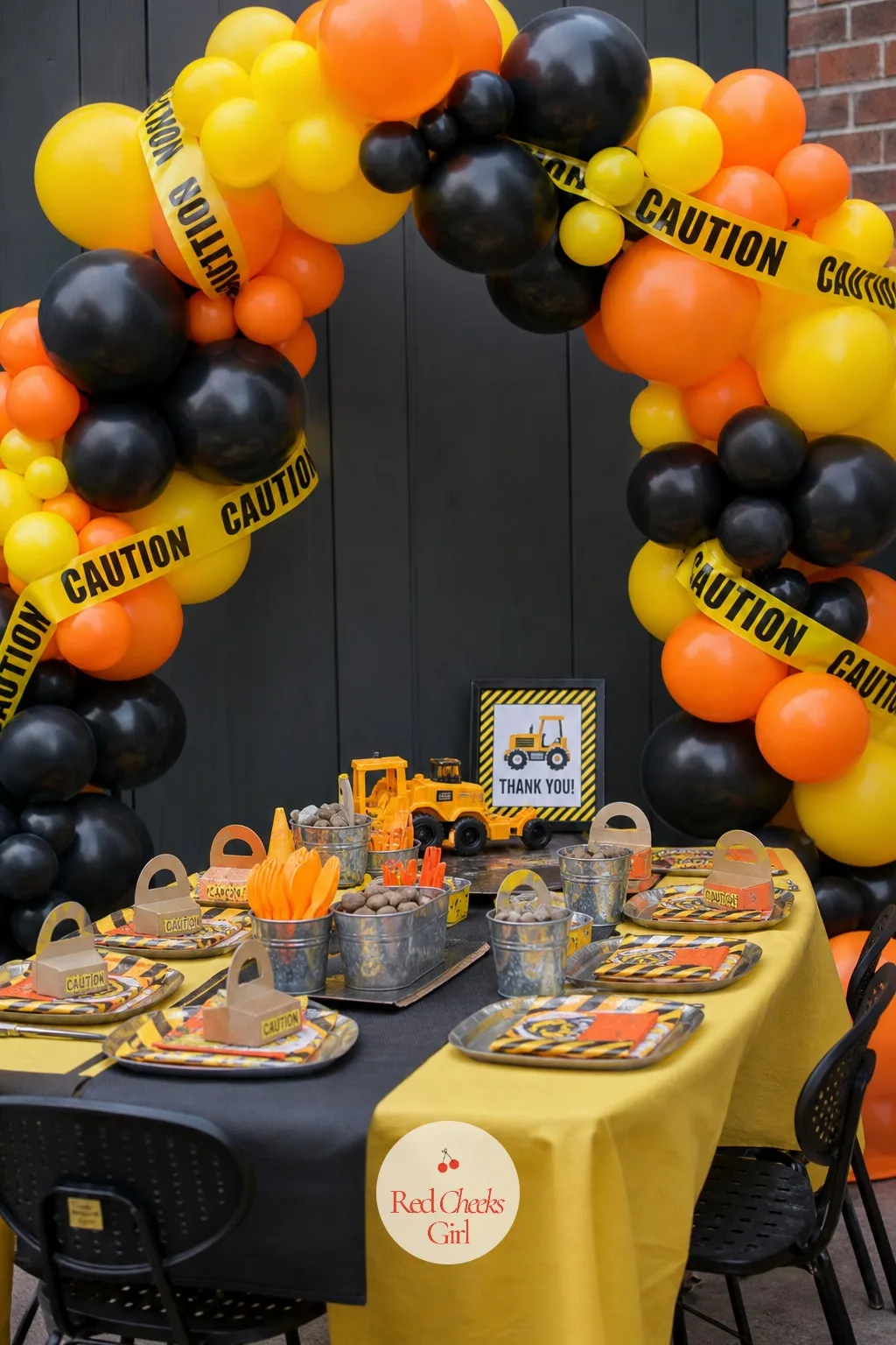 Caution Stripe Balloon Arch Over The Table — An arch overhead makes any folding table feel like an occasion, and this one reads as a job site the moment the