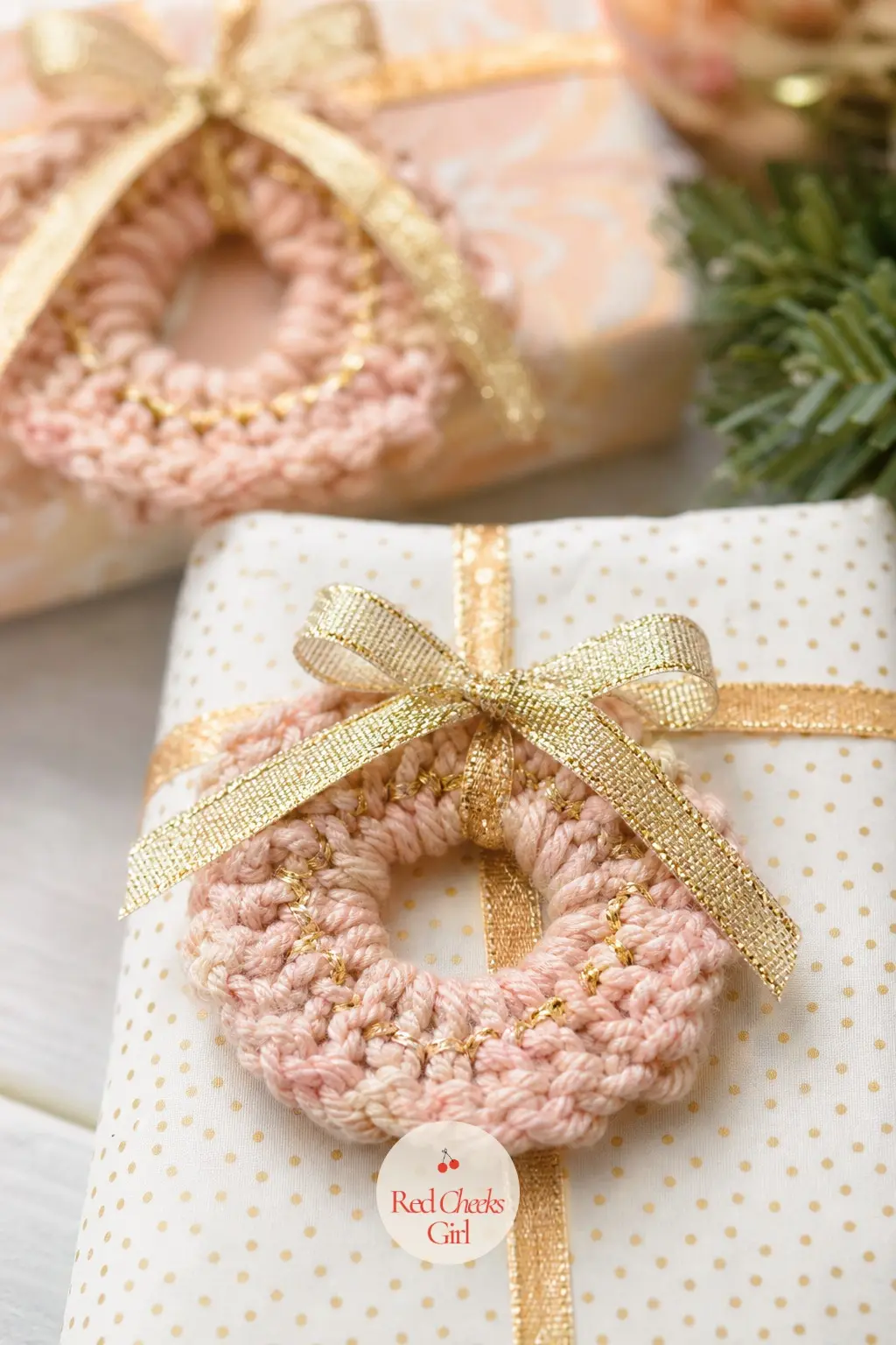 The Blush and Gold Thread Crochet Wreath Gift Toppers for the Present Table — Two-inch crochet rings in blush pink with a thread of gold sit on top of wrapped