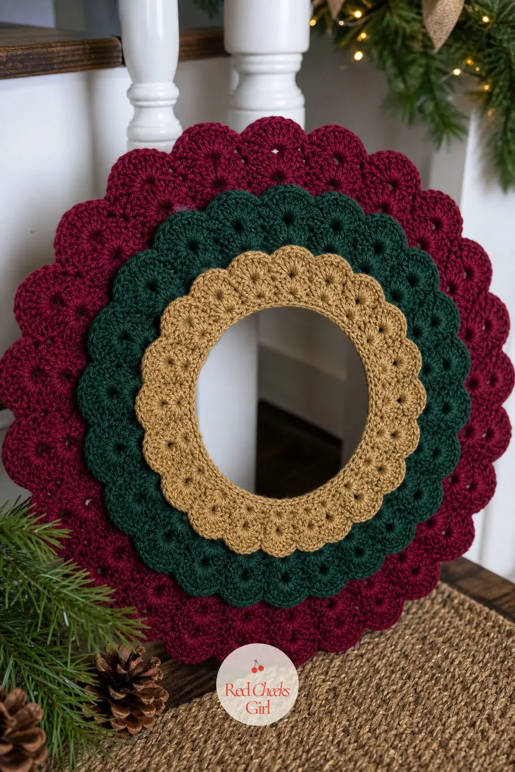 The Layered Burgundy and Forest Multi-Ring Wreath for the Staircase Landing — Three crochet rings of different sizes, in burgundy, forest green and a narrow