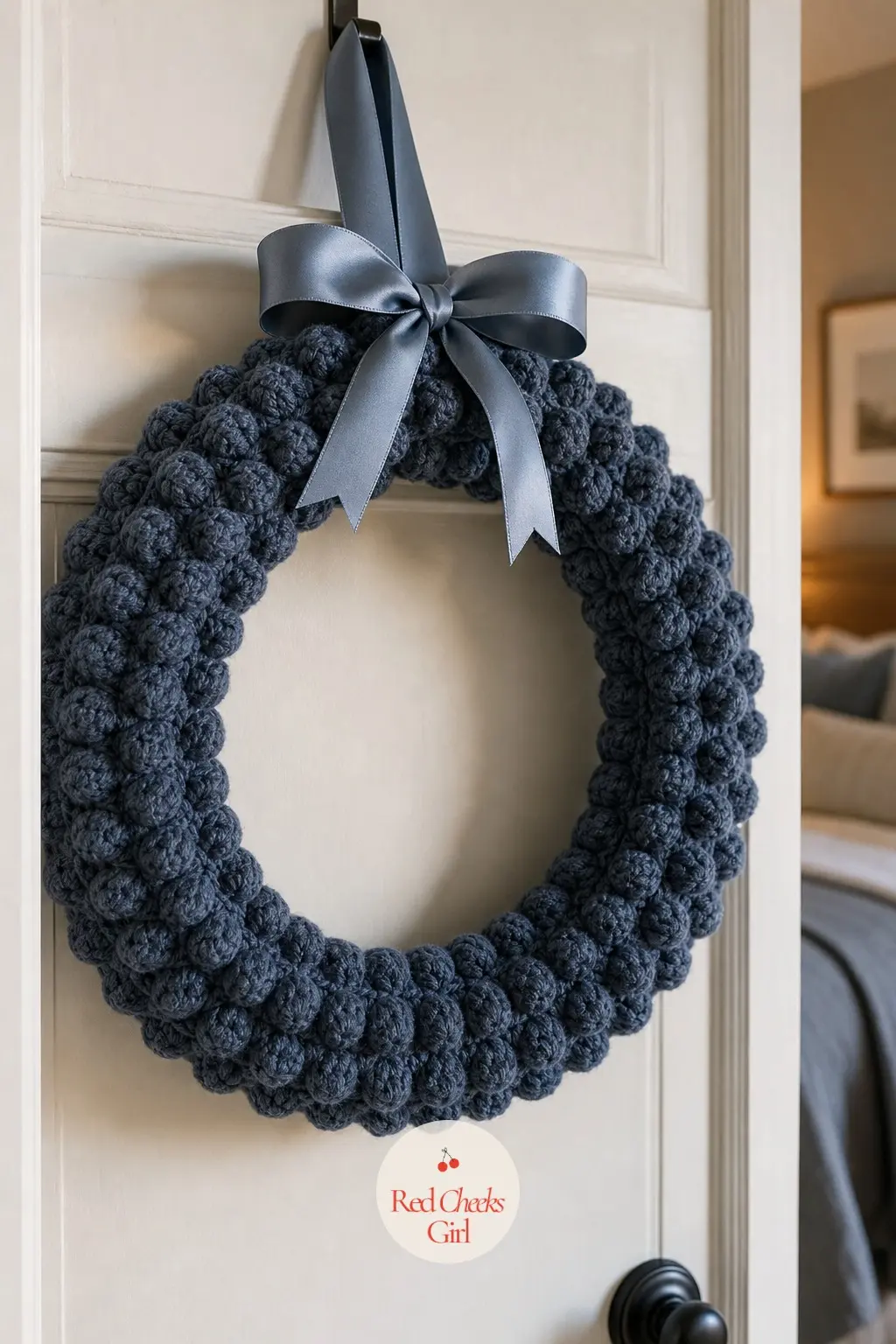 The Slate Blue Bobble Stitch Wreath for the Bedroom Door — Rows of bobble stitch in slate blue give this wreath a raised, almost quilted surface, hung on a