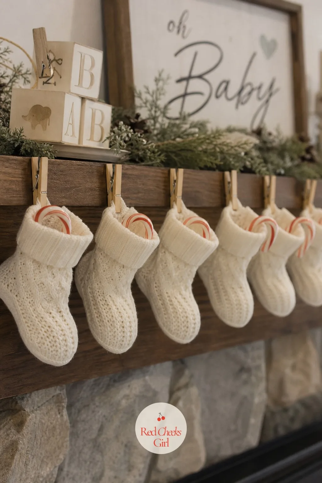 Baby Socks as Stockings — A small pair of white knit baby socks stands in for the stocking itself, each one stuffed with a candy cane and a tiny favor, pegged