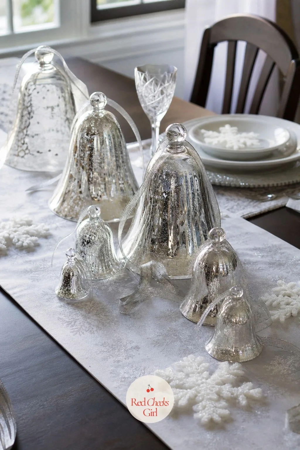 Glass Bell Centerpieces — Nothing dated about a real bell done properly: clear and silver glass bells of varying sizes cluster down the center of the table