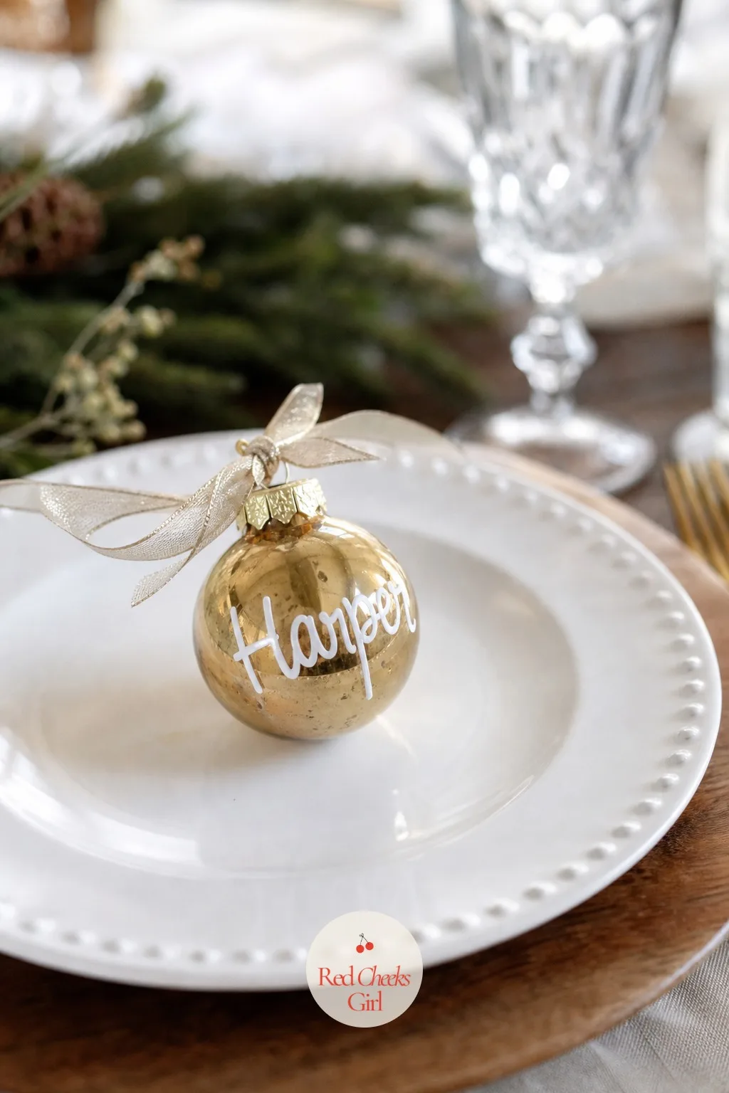 The Place Card Ornament at Every Setting — At each place setting, lean a small glass or ceramic ornament against the plate instead of a paper place card, with