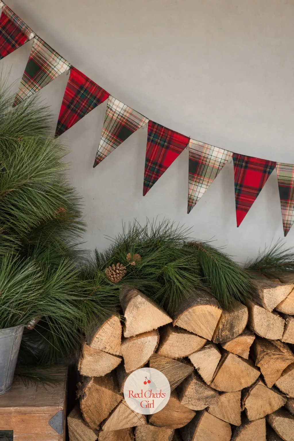 A Plaid Birthday Banner Over Stacked Firewood — No working fireplace does not mean no fireplace feeling. December birthday party ideas