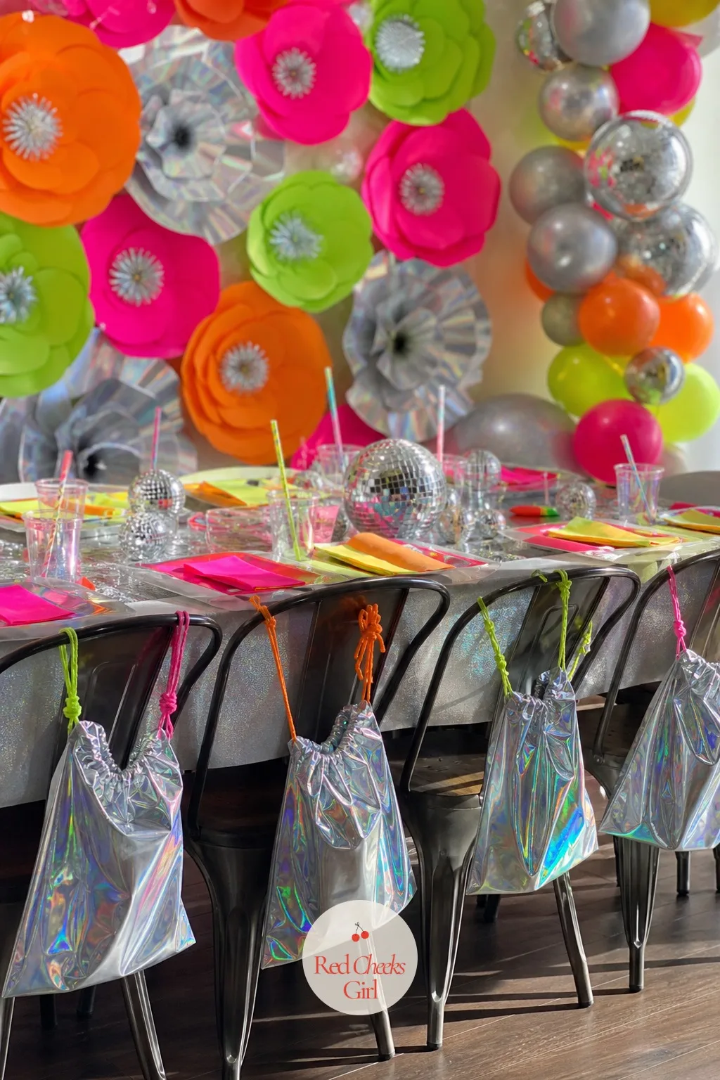 Holographic Goodie Bags Lined Up — A single bag at every place setting tells each guest, before she has even opened it, that this one was for her. Disco themed