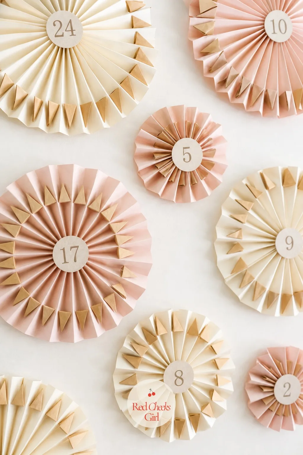 Paper Fan Countdown — Flat, fast and nearly free: pleated paper fans in blush and cream open against a plain wall, a corner of folded paper tucked into each