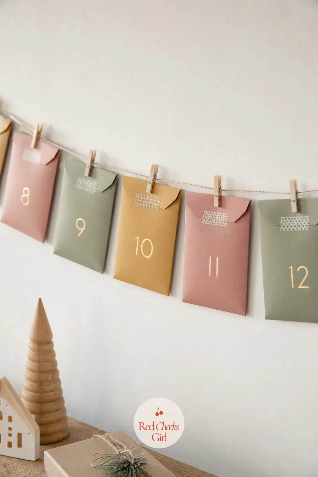 Washi-Taped Envelope Garland — A hallway that looks fine eleven months of the year suddenly feels bare in December, and this fixes that in an afternoon. Diy