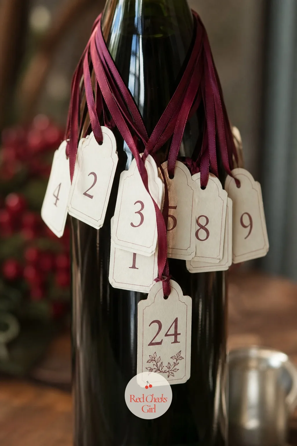 Wine Bottle Ribbon Countdown — One bottle, saved and wrapped at the neck with small burgundy ribbon loops, each tied to a cream tag naming one five-minute