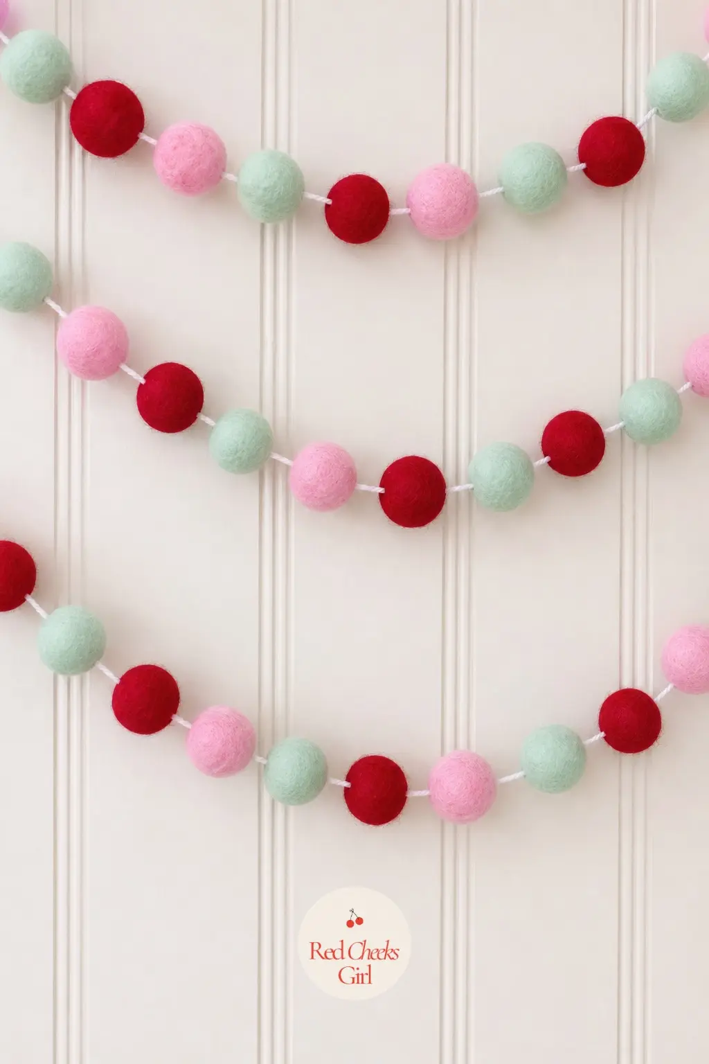 Felt Ball Candy Garland — Pre-made wool felt balls in bubblegum pink, mint and cherry red thread onto cotton cord in minutes, with no sewing and no drying