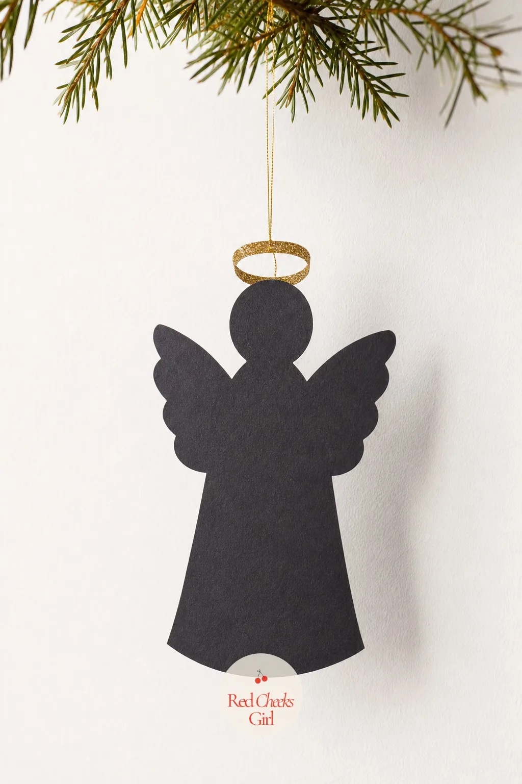 Black Cut-Paper Angel Silhouette — A single silhouette, scissor cut from black card, reads as a Victorian scrapbook piece rather than anything from this