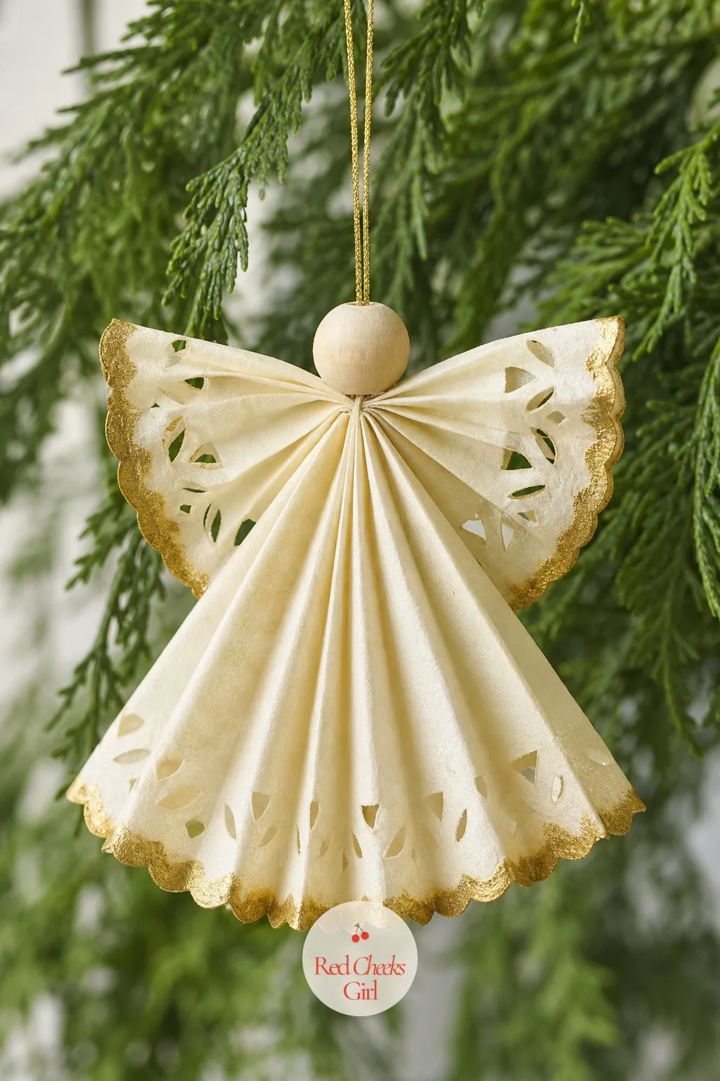 Coffee Filter Snowflake Angel — A coffee filter, folded and snipped the same way as a paper snowflake, opens into a soft, rounded shape that drapes rather than