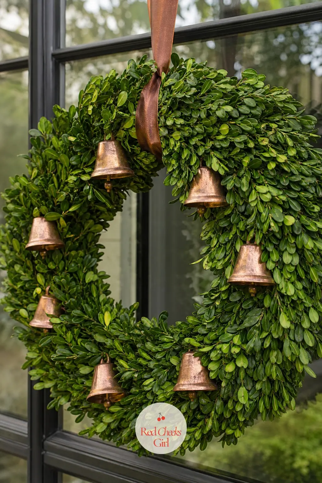 The Preserved Boxwood and Copper Bell Wreath for the Conservatory Window — Copper reads warmer than brass or gold and sits well against the deep matte green of