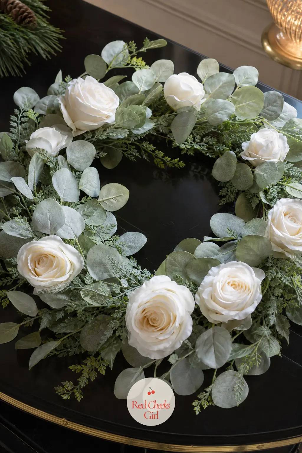 The Winter White Rose and Silver Dollar Fern Wreath for the Piano — Faux white roses against rounded silver dollar fern leaves keep this one soft and pale