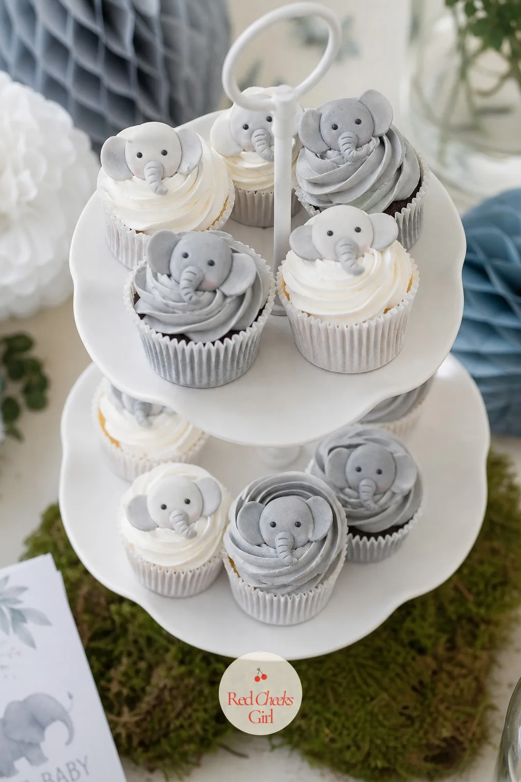 Cupcakes Frosted With Little Elephants — Cupcakes do the heavy lifting on any dessert table because they need no slicing and no plates. Elephant baby shower