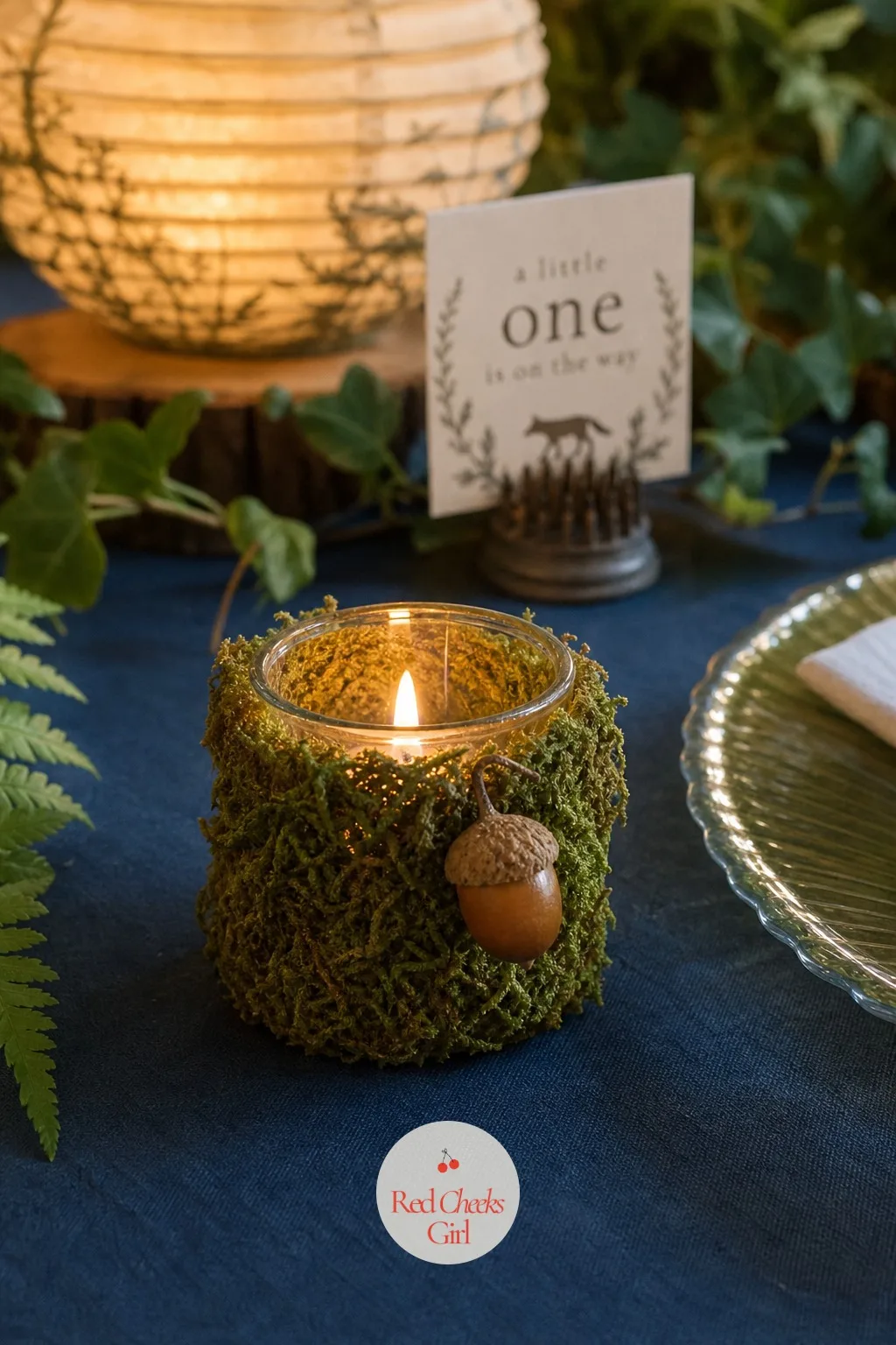 A Moss-and-Acorn Votive Candle — A plain glass votive is forgettable. Enchanted forest theme baby shower ideas