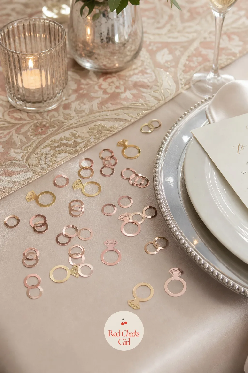 Confetti on Tables — A light scatter of metallic ring and heart confetti sits near the place settings and dessert plates, catching the lamp light in small