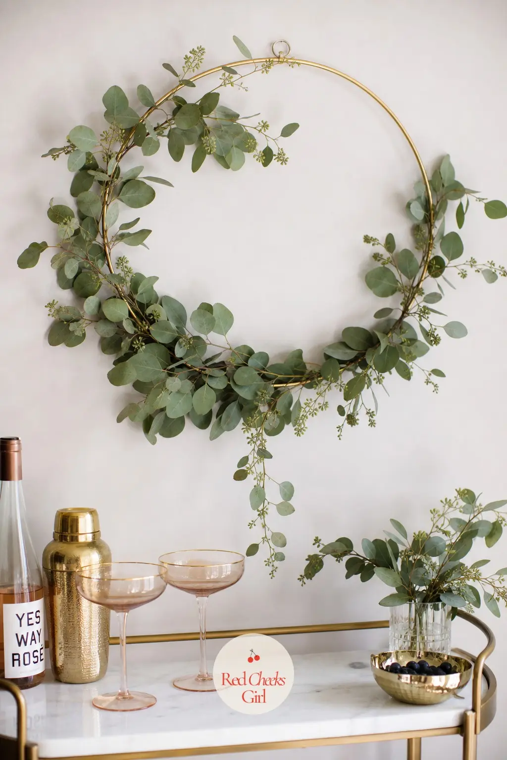 The Brass Hoop Eucalyptus Wreath for the Bar Cart Wall — A slim brass hoop, left mostly bare, with eucalyptus wound loosely around only part of the ring, looks