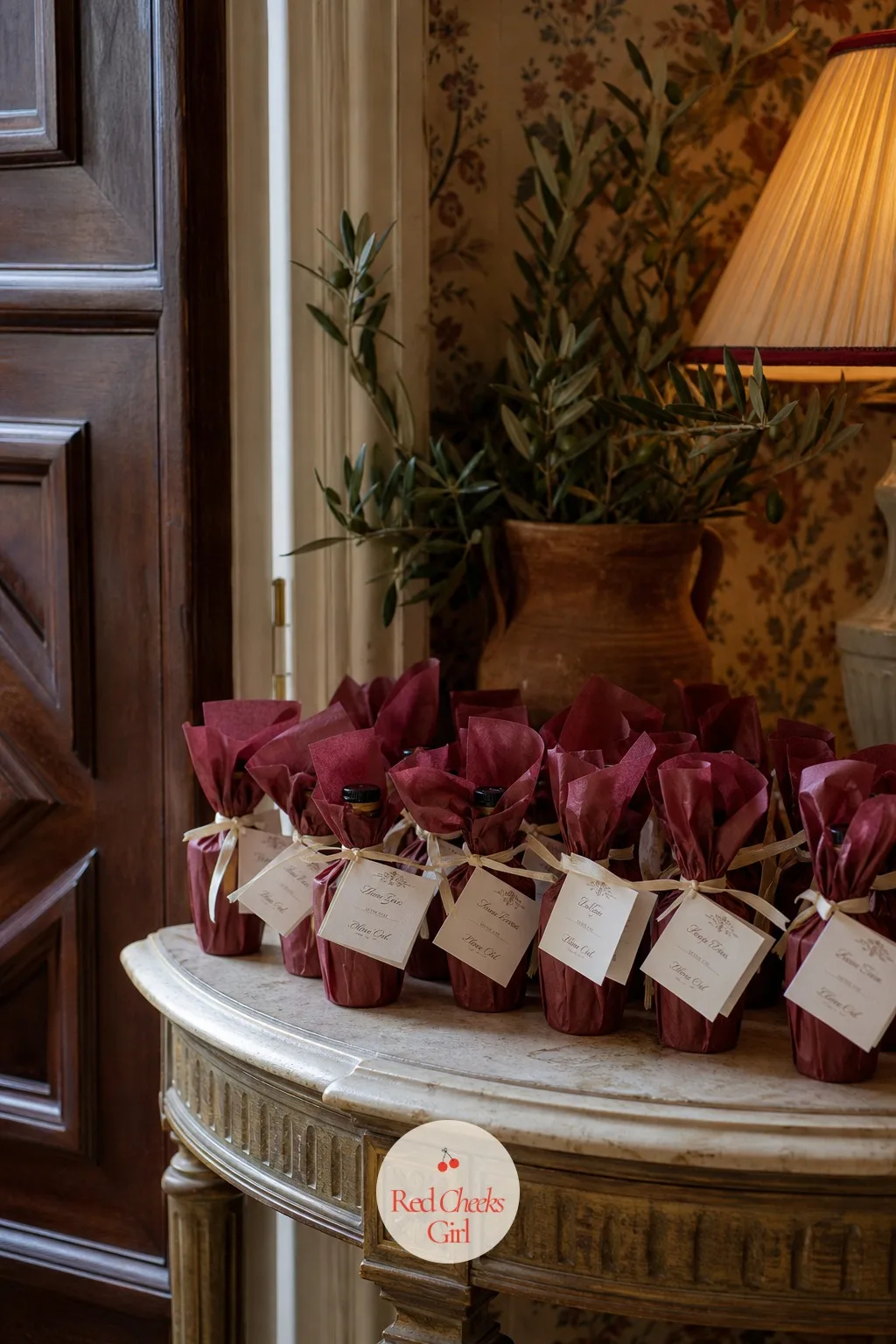 Olive Oil Favors Wrapped in Wine-Red Wax Paper — A favor that sits unused on a shelf afterward is money spent for nothing. European wedding aesthetic