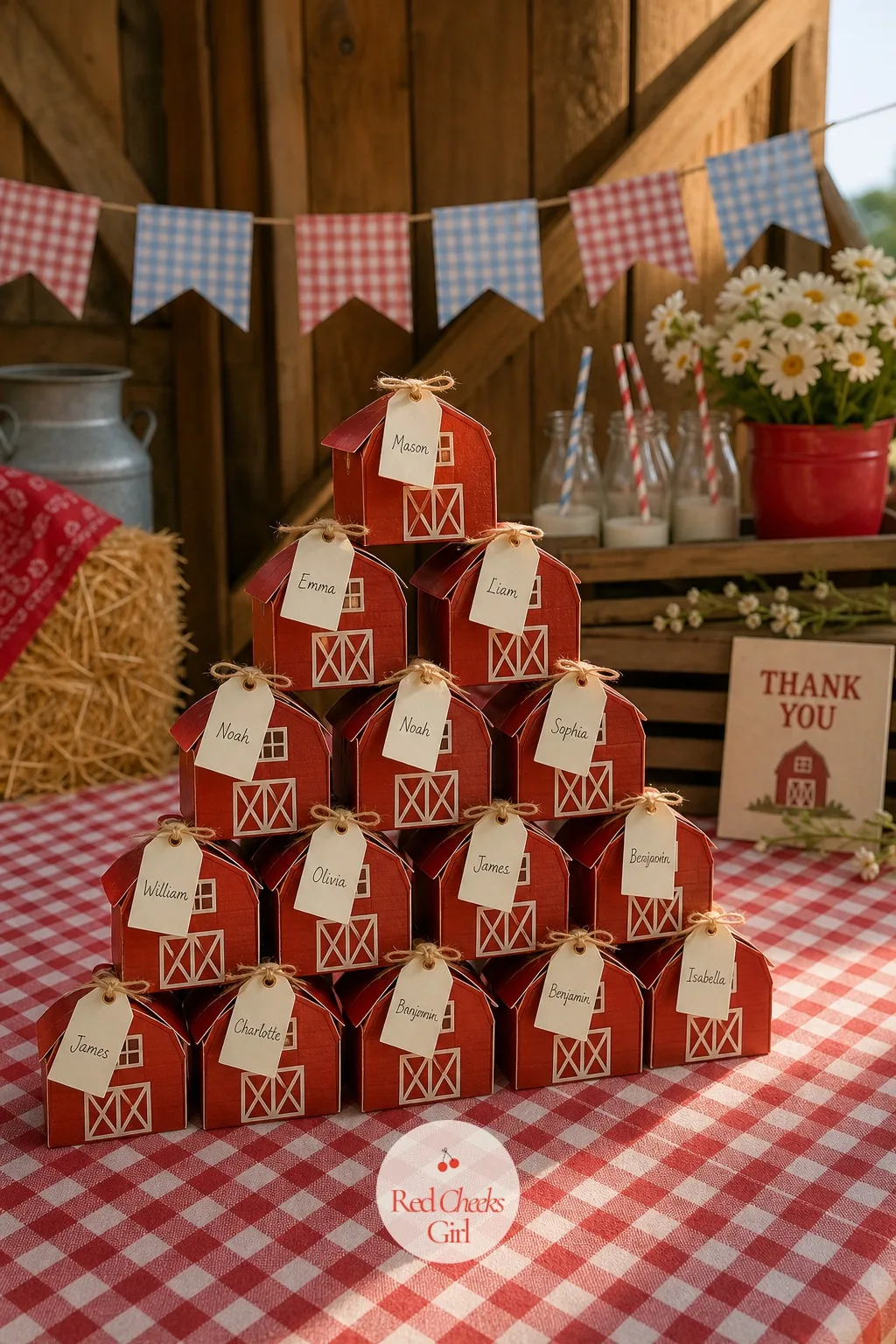 Barn Box Favor Tower on a Gingham Table — Small favor boxes folded into the shape of red barns, complete with a cream roofline and a tiny painted door, stack
