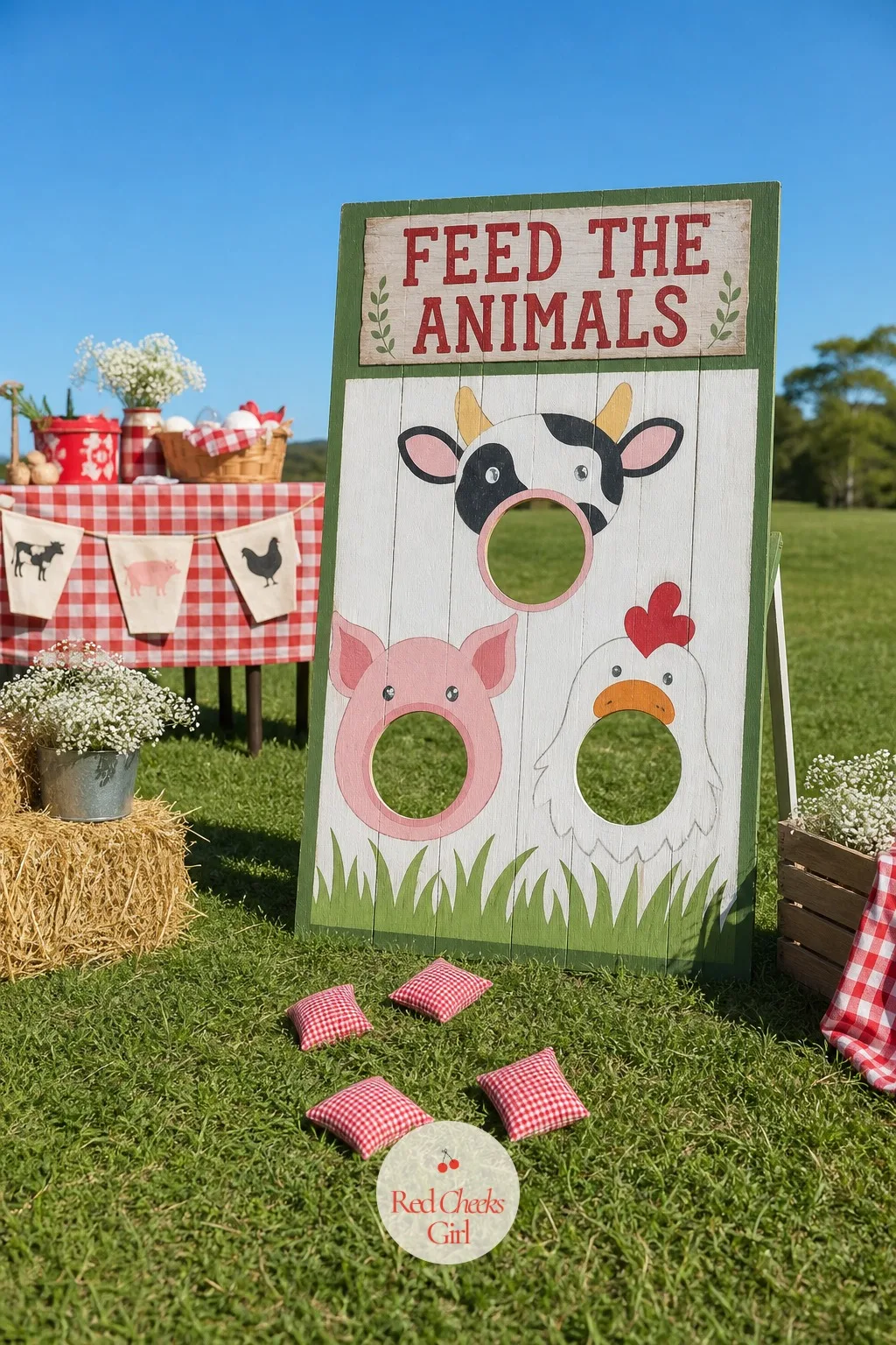 Feed the Animals Bean Bag Toss on the Lawn — A target board of painted cow, pig and chicken faces, each with an open mouth cut through for a hole, stands on