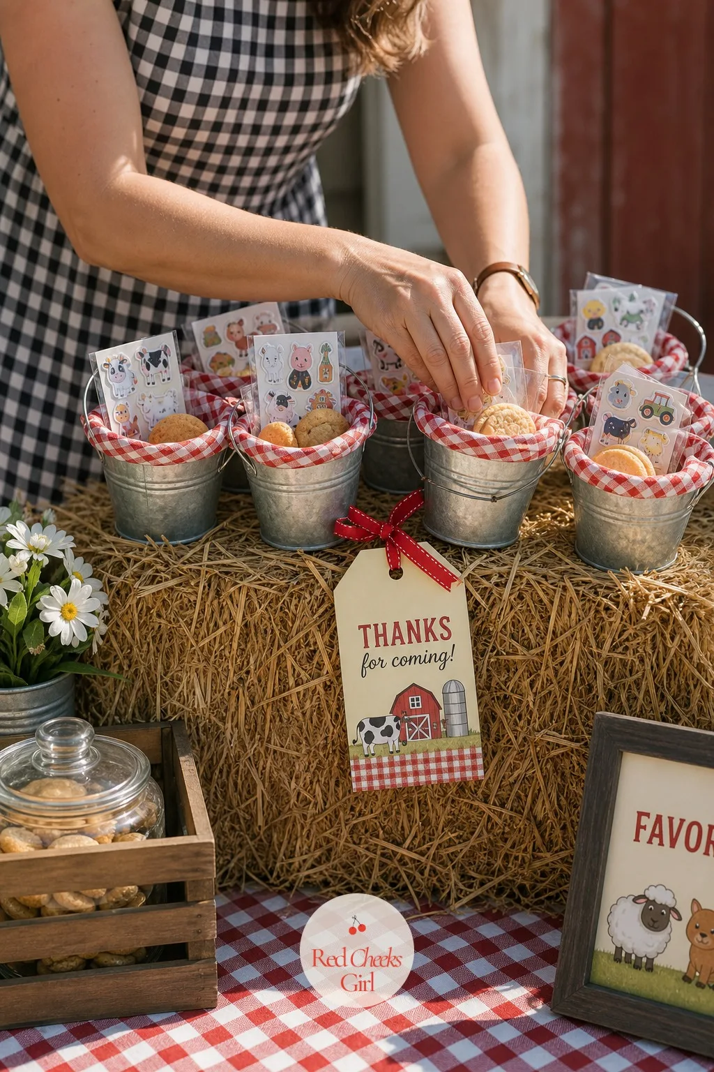 Galvanized Bucket Favor Station on a Hay Bale — A row of small galvanized buckets lined with gingham fabric sits along the top of a hay bale, each one filled