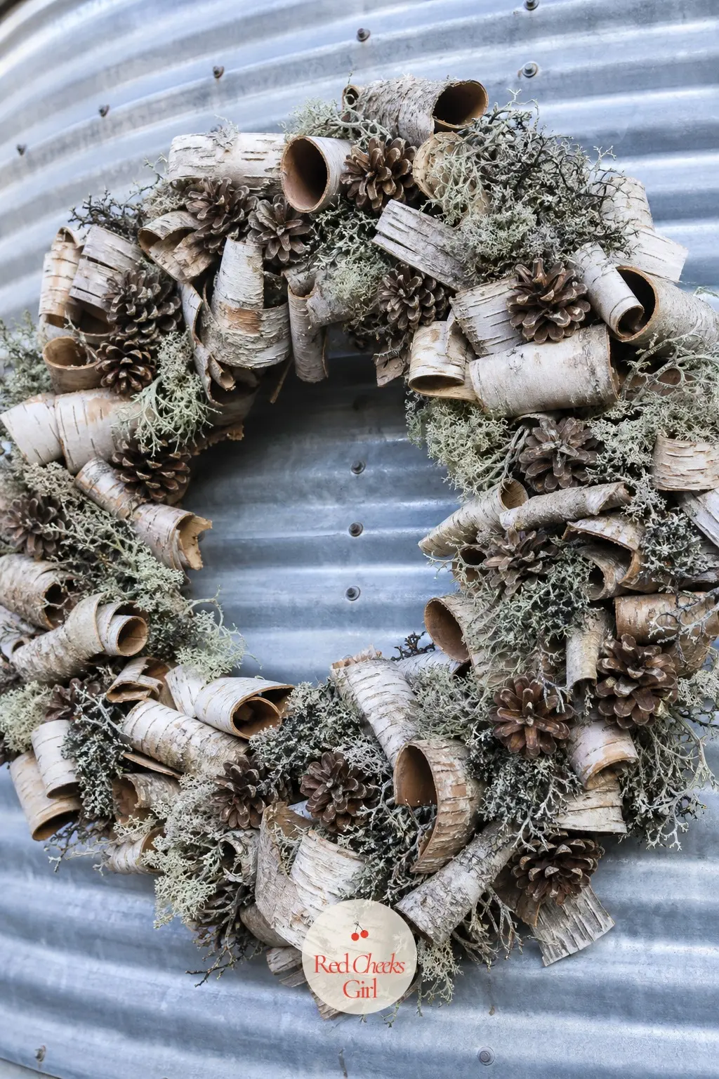 The Birch Bark and Pinecone Wreath for the Silo Wall — Curls of white birch bark layer over natural pinecones and a touch of grey-green lichen, built to read